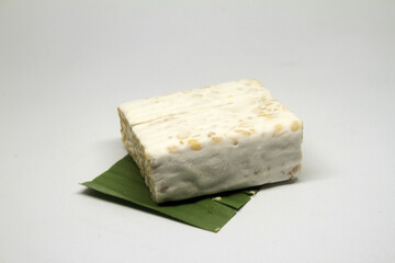 Slice of tempeh or tempe made of fermentation process that binds soybeans, is traditional food from Indonesia and Malaysia
