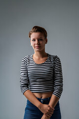 Young woman posing wearing striped shirt and jeans