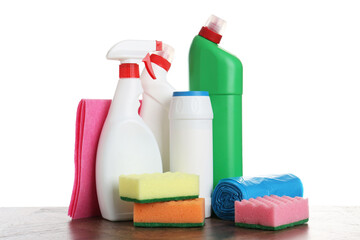 Different toilet cleaners, sponges, rag and trash bags on wooden table against white background