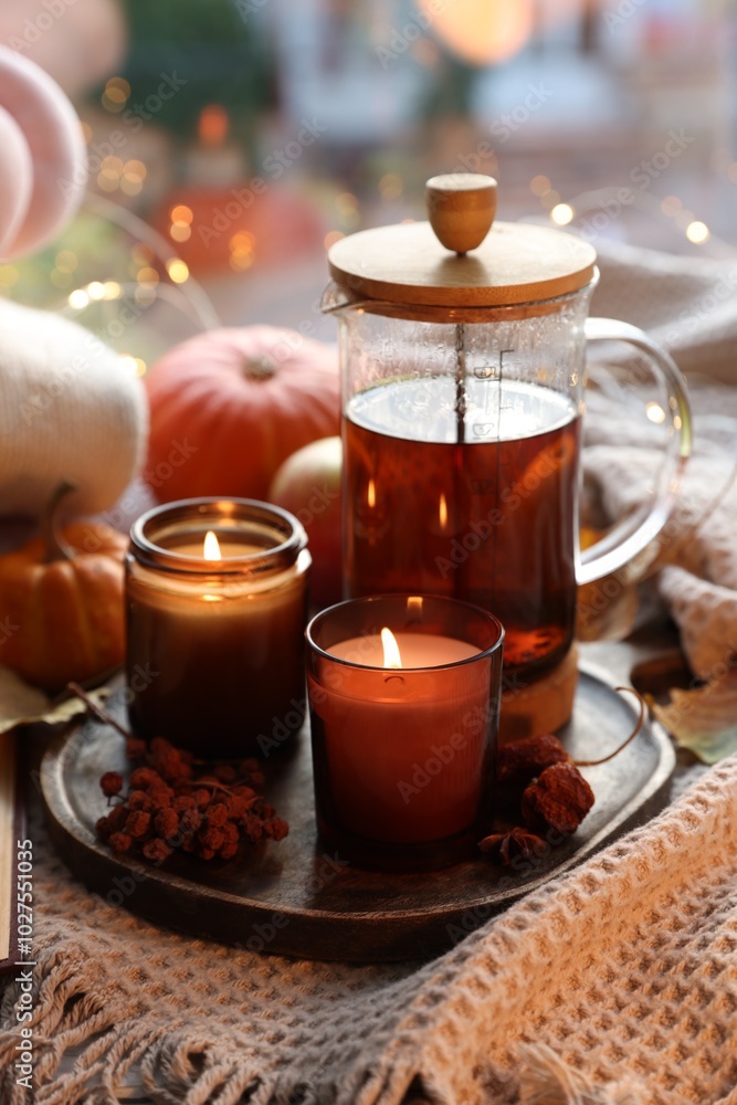 Wall mural Burning candles, freshly brewed tea and autumn decor on fabric