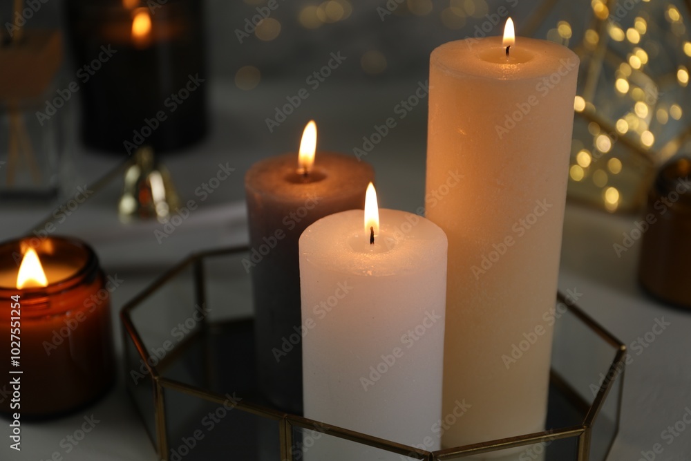 Canvas Prints Beautiful burning candles on table against blurred lights, closeup