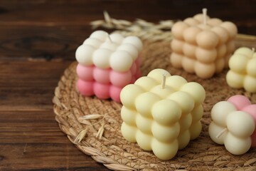 Different stylish bubble candles on wooden table, closeup. Space for text