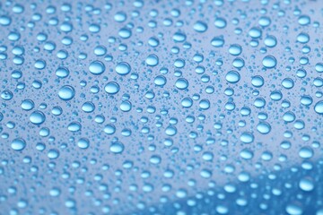Water drops on blue background, closeup view