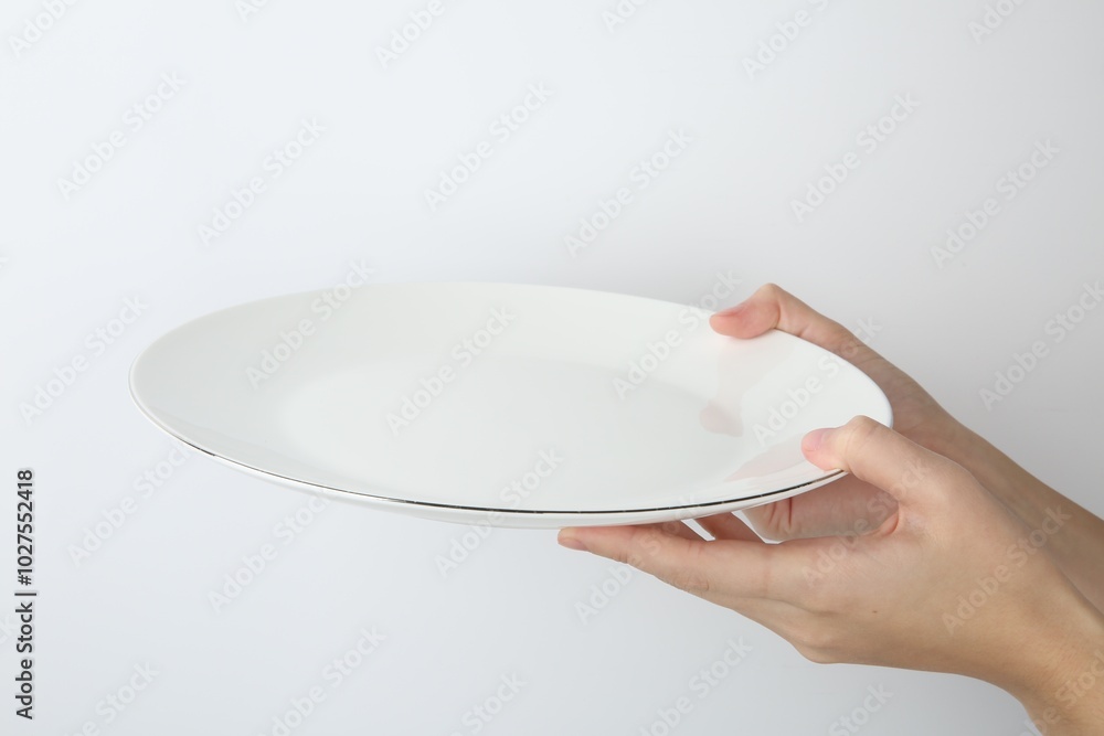 Canvas Prints Woman with empty ceramic plate on white background, closeup