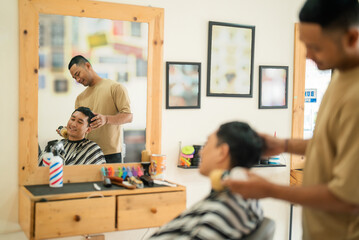 A man is currently having his hair cut by a skilled barber in a cozy barber shop, surrounded by various hair styling tools and equipment