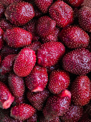 Texture of sweet fresh strawberries as background, closeup. Strawberry background. Red ripe organic strawberries on market counter. Ripe fresh strawberries. Red berries freshly harvested strawberries