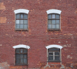 Four windows in the old red brick wall