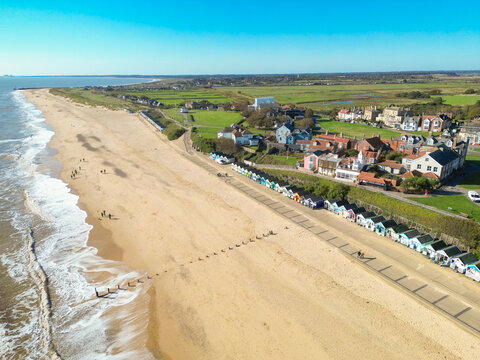 Fototapeta Wonderful aerial image of the famous Southwold, Suffolk, UK coastline in early autumn. The long row of famous wooden beach huts can be seen overlooking the golden beach.