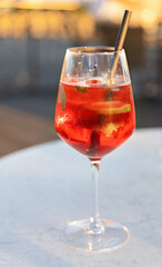 tarnished wine glass filled with Lillet wild berry and metal straw