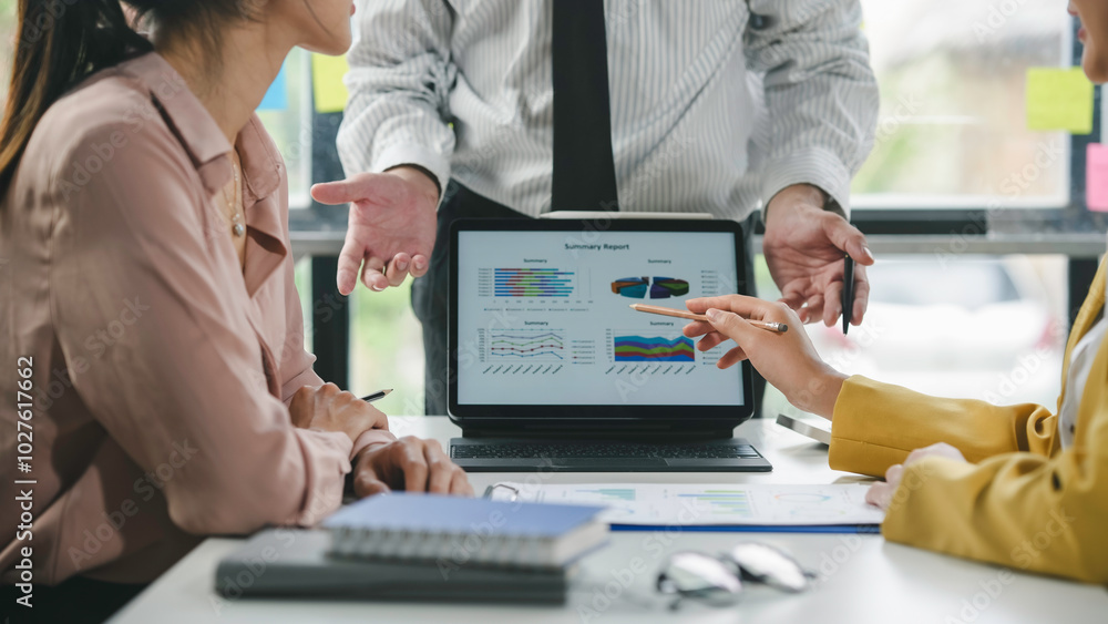 Poster business team discussing financial data displayed on a tablet during a meeting, showcasing teamwork 