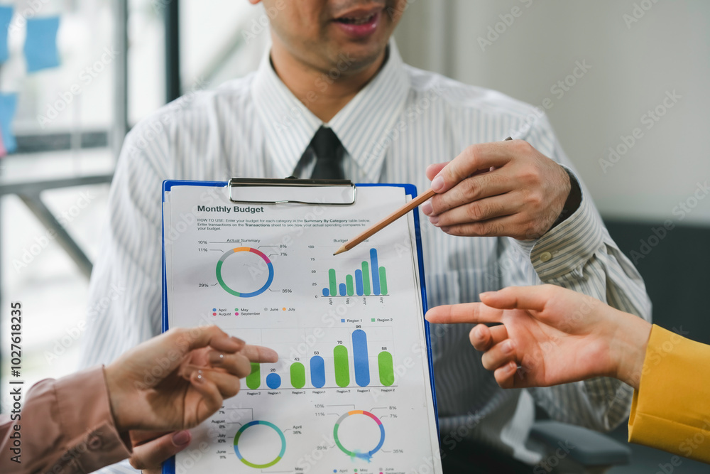 Poster business team having a discussion and analyzing monthly budget using charts and graphs