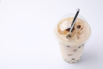 Tasty milk bubble tea in plastic cup on white background, space for text