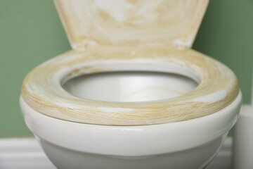 Toilet with dirty seat in public restroom, closeup