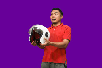 Mature Asian man wearing red t-shirt holding motorbike helmet smiling
