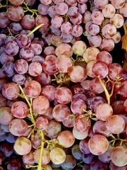 grapes lie in a basket on a shelf in a store