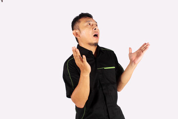 An Asian adult man opens his arms with a surprised expression.