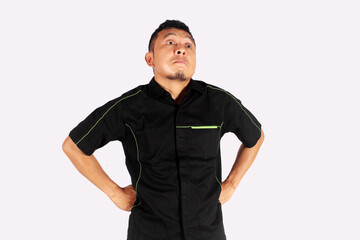 a man in black standing with his hands on his hips