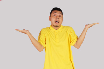 An Asian adult man opens his arms with a surprised expression.