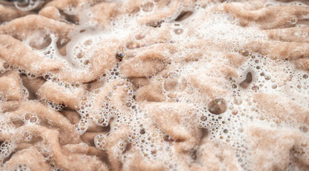 Cashmere Sweater Being Soaked and Washed in Delicate Soapy Water