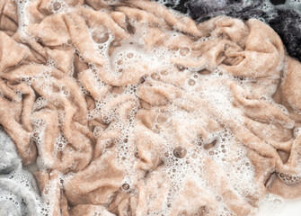 Cashmere Sweater Being Soaked and Washed in Delicate Soapy Water