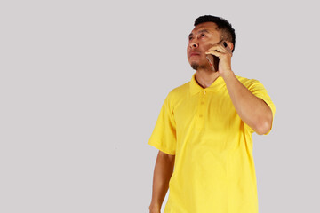 young businessman confused and serious while making a phone call
