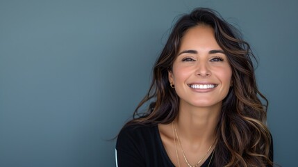 Naklejka premium A cheerful Hispanic woman showcases her bright smile against a vibrant backdrop
