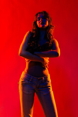 Young girl in red light, play of light and shadow