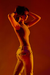 Young girl in red light, play of light and shadow