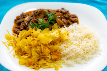 Traditional filet mignon stroganoff with mushrooms, French fries and rice