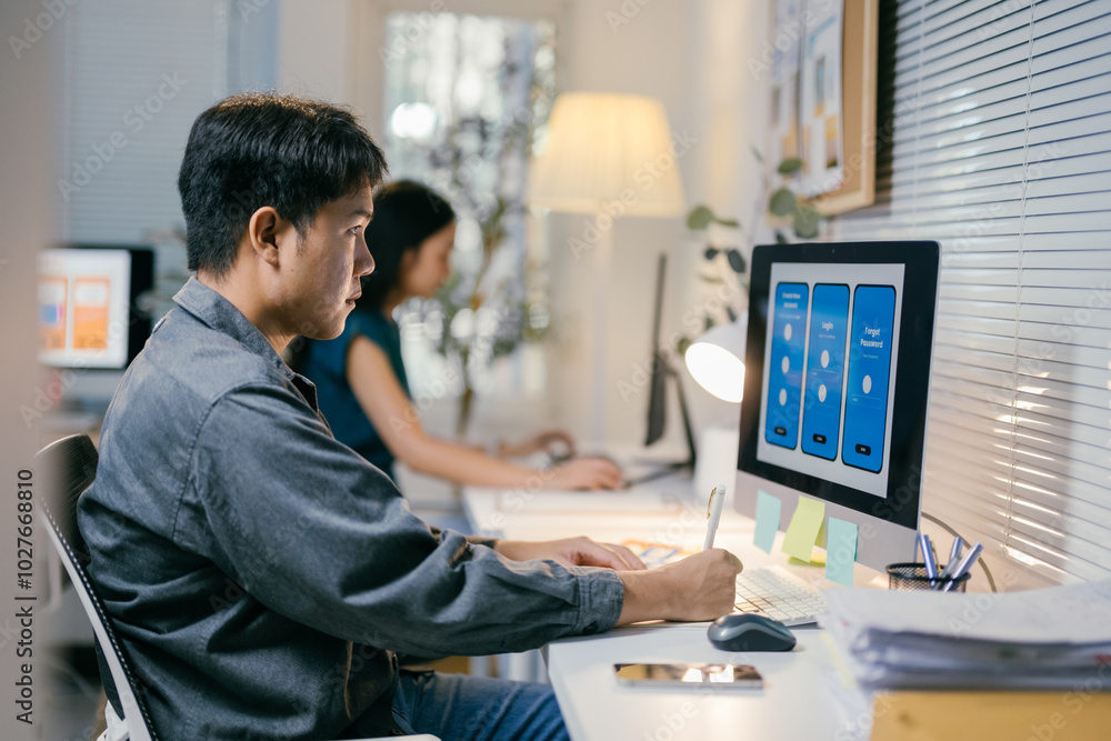 Aufkleber Two asian ui/ux designers are working together in the office, developing the user interface of a new mobile application