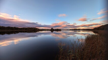 Beautiful orange sunset lakeside landscape scenery at Ross lake, Roscahill, Galway, Ireland, nature background