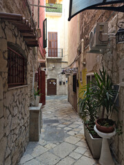 Narrow street in the old town center. Architecture of historic tenement houses in the Italian city. Bari, Puglia, Italy.