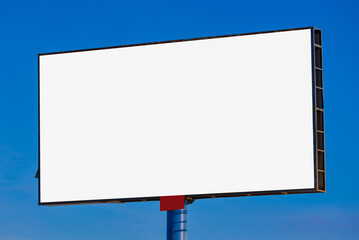 Fototapeta premium white billboard along the highway on a winter snow day. Background for design and advertising. 
