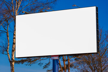 white billboard along the highway on a winter snow day. Background for design and advertising. 