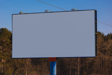 Billboard along the road and highway on a winter snow day. Background for design and advertising. 