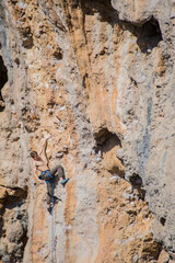 A rock climber ascends to the summit via a difficult route.