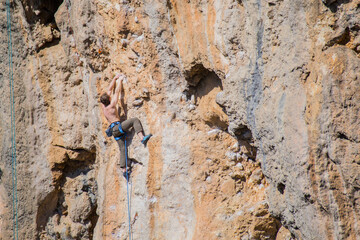 A rock climber ascends to the summit via a difficult route.
