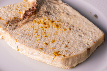 baked emperor fish fillet with curry on a white plate freshly cooked