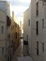 Elevation of buildings in a narrow street in the center of the old town. Bari, Italy.