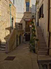 Obraz premium Narrow street in the old town center. Facade of old buildings. Puglia, Italy.