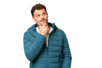 Brazilian man over isolated chroma key background and looking up