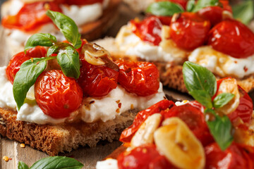 Cottage cheese and roasted tomatoes sourdough bread toast on a wooden board.