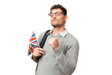 Brazilian man holding an United Kingdom flag over isolated chroma key background proud and...