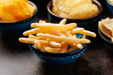 Set of different crispy potato chips in bowls. Snack food