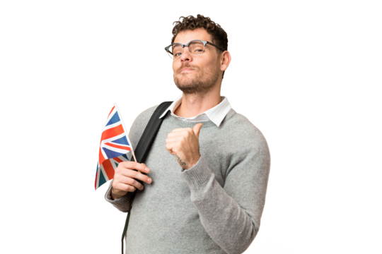Brazilian man holding an United Kingdom flag over isolated chroma key background proud and self-satisfied