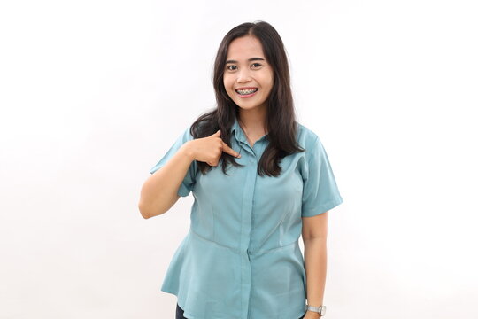 Happy smiling Asian woman points at herself, confident satisfied expression, models over white background