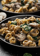 Chestnut Mushrooms and spinach tortellini served with parmesan cheese