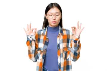 Young Asian woman over isolated chroma key background in zen pose
