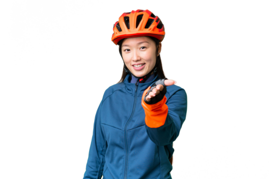 Young cyclist woman over isolated chroma key background shaking hands for closing a good deal