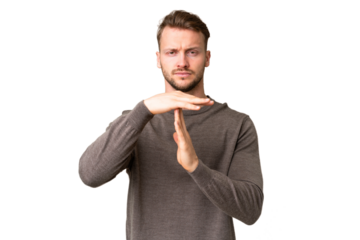 Young handsome caucasian man over isolated chroma key background making time out gesture